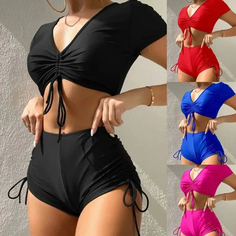 Lady in dark green lace-up bow swimsuit with matching shorts, adjustable front tie.