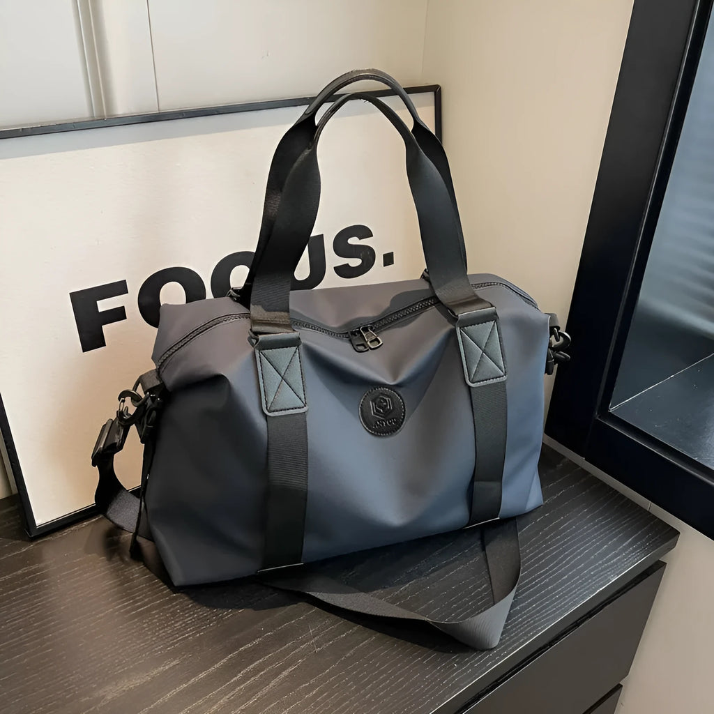 Large black waterproof Oxford cloth travel rucksack with multiple compartments shown on a grey background.