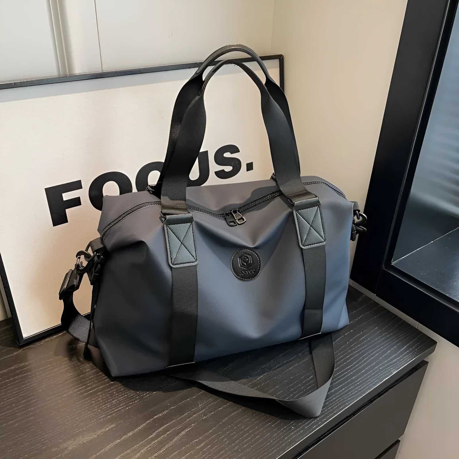 Large black waterproof Oxford cloth travel rucksack with multiple compartments shown on a grey background.