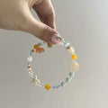 Water-soaked orange sea summer bracelet with diamond shape and round alloy elements for female wearers