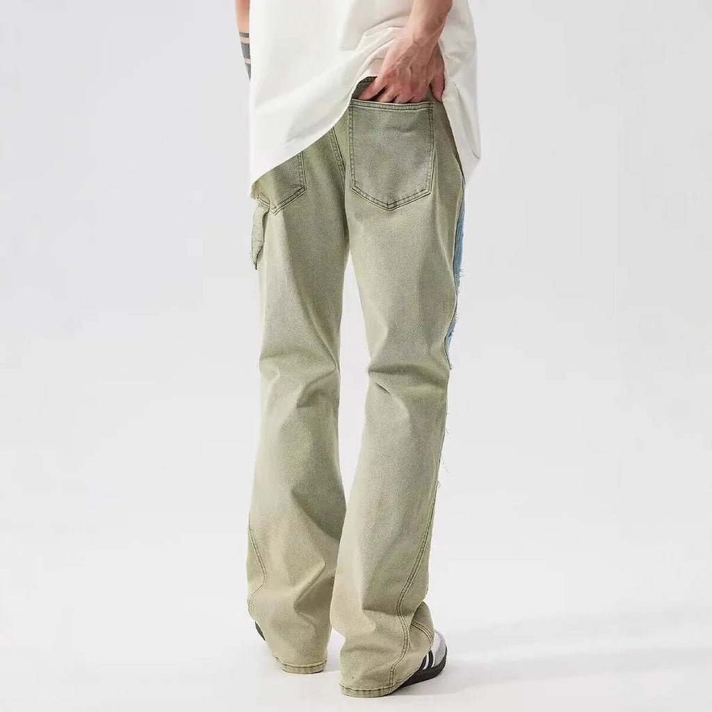 Retro dual-colour patchwork jeans with yellow and blue sections, splash-ink patterns, and distressed detailing on mid-waist denim trousers