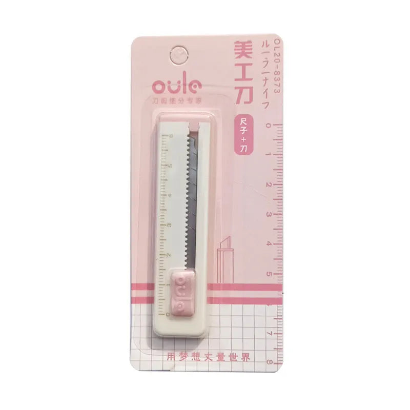 Small plastic-bladed art knife in blue, khaki, orange, pink, and purple colours, showing 7.2 cm size.