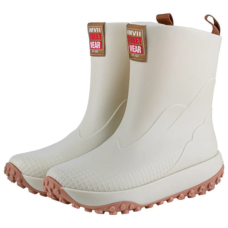 Men's mid-height PVC rain boot in beige with round toe and plastic sole.