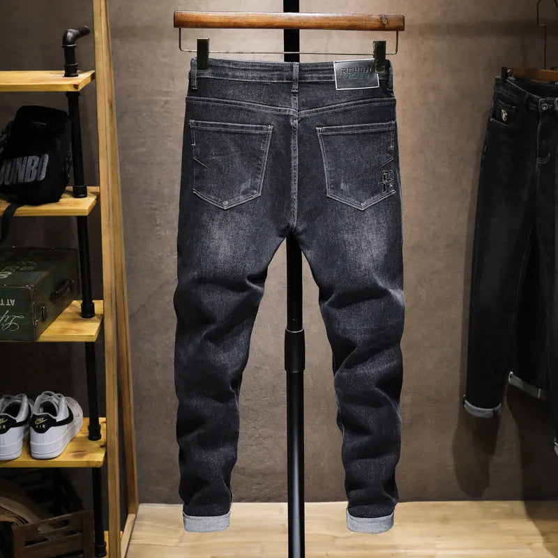 Men's dark grey loose straight-leg cotton denim jeans with mid waist, zip fly and cat whisker finish