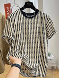 Men's black striped short-sleeve shirt with loose fit, made from linen and silk blend, shown in casual wear.