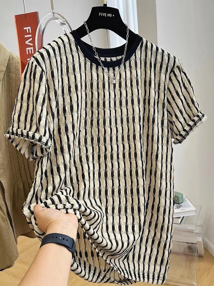 Men's black striped short-sleeve shirt with loose fit, made from linen and silk blend, shown in casual wear.