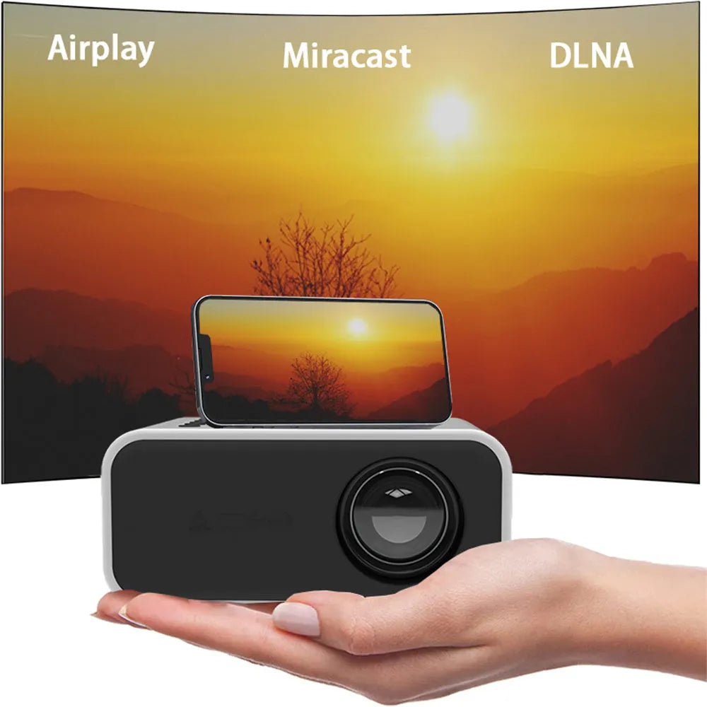 Black YT300 portable mini projector on a table, projecting a movie scene onto a wall.