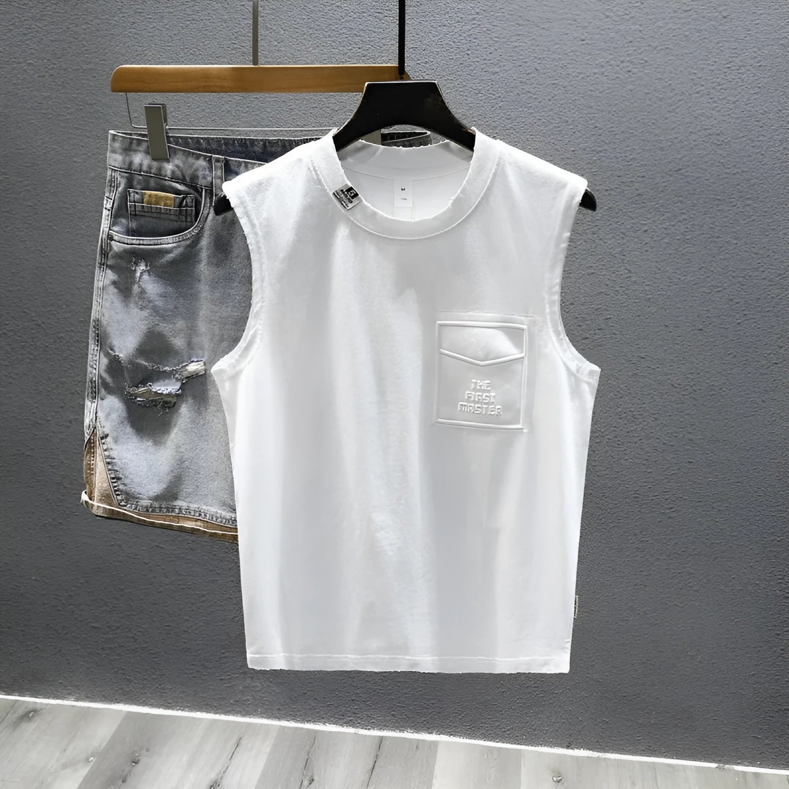 Solid colour loose fit cotton sleeveless t-shirt on a hanger, shown in black and white colour options.