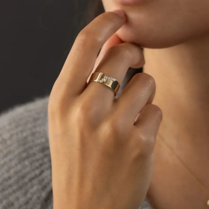 Women's gold electroplated copper ring with zircon stone, showing side and top views