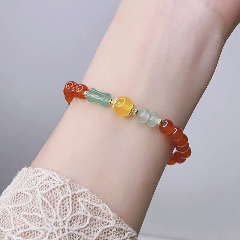 Women's handcrafted red agate bracelet with Chinese dragon design and lucky charm elements