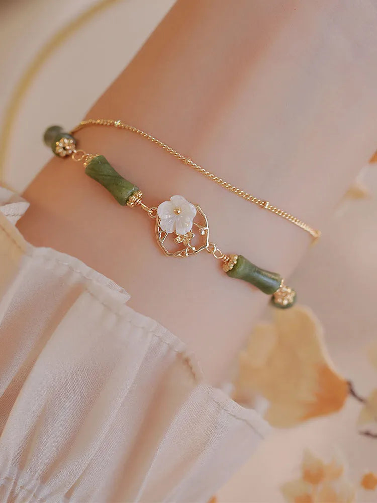 Natural olivine bracelet with double layer design featuring twin bells and olive branch motif