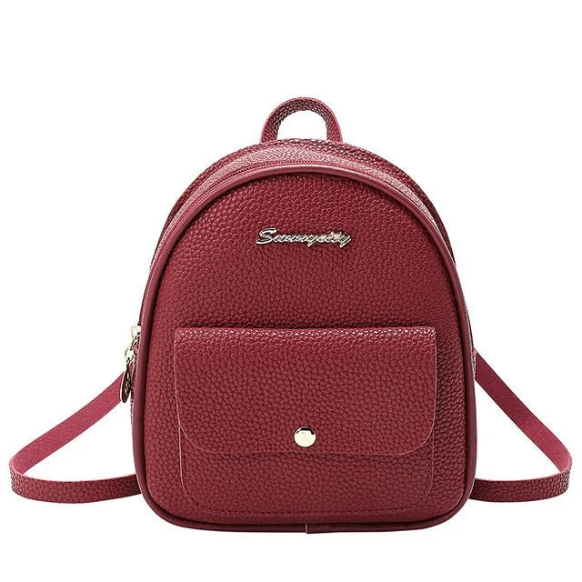 Women's small black backpack purse with adjustable straps showing 18.5cm length and zipper closure