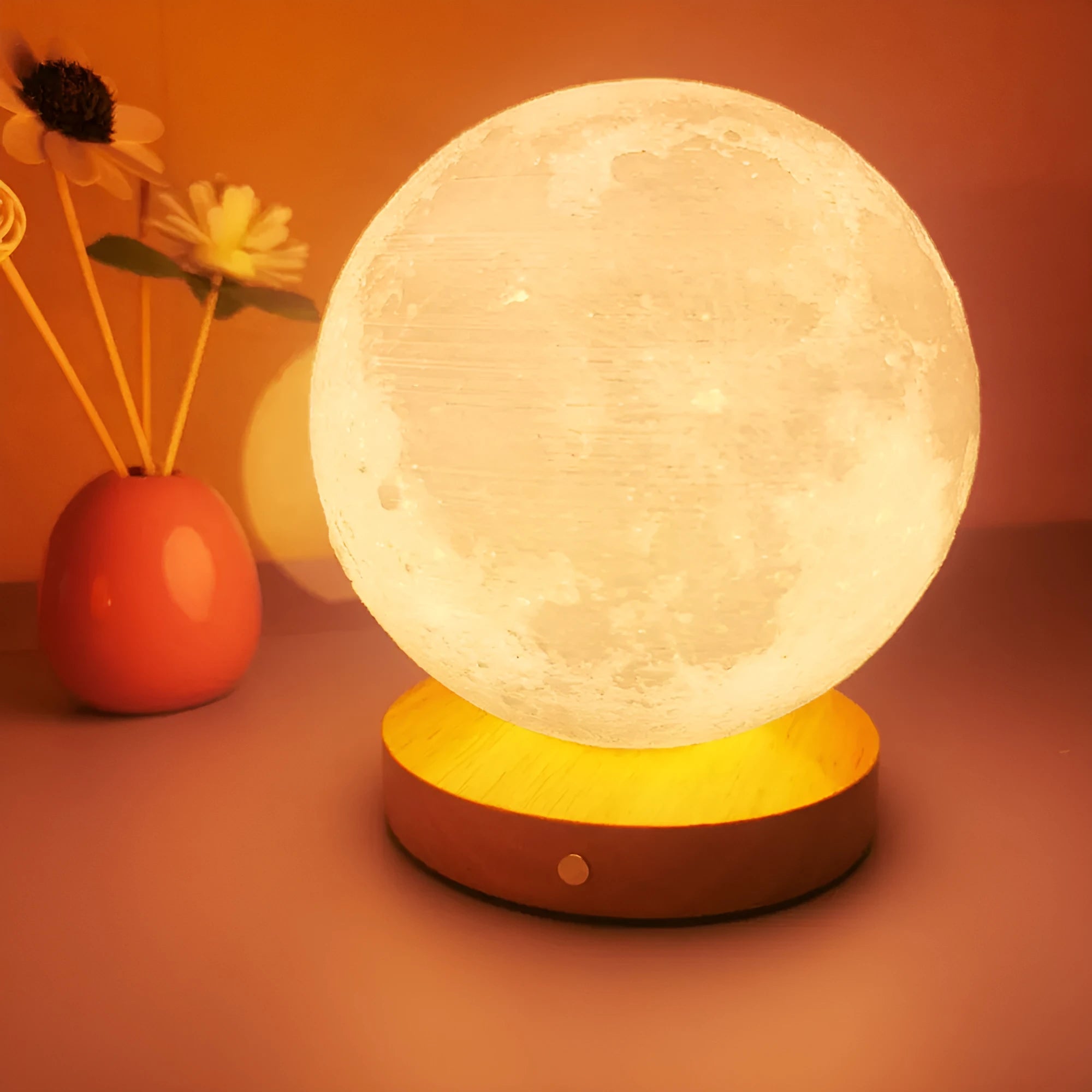 Rotating sleeping moon night lamp on a wooden base, showing three-colour light options.