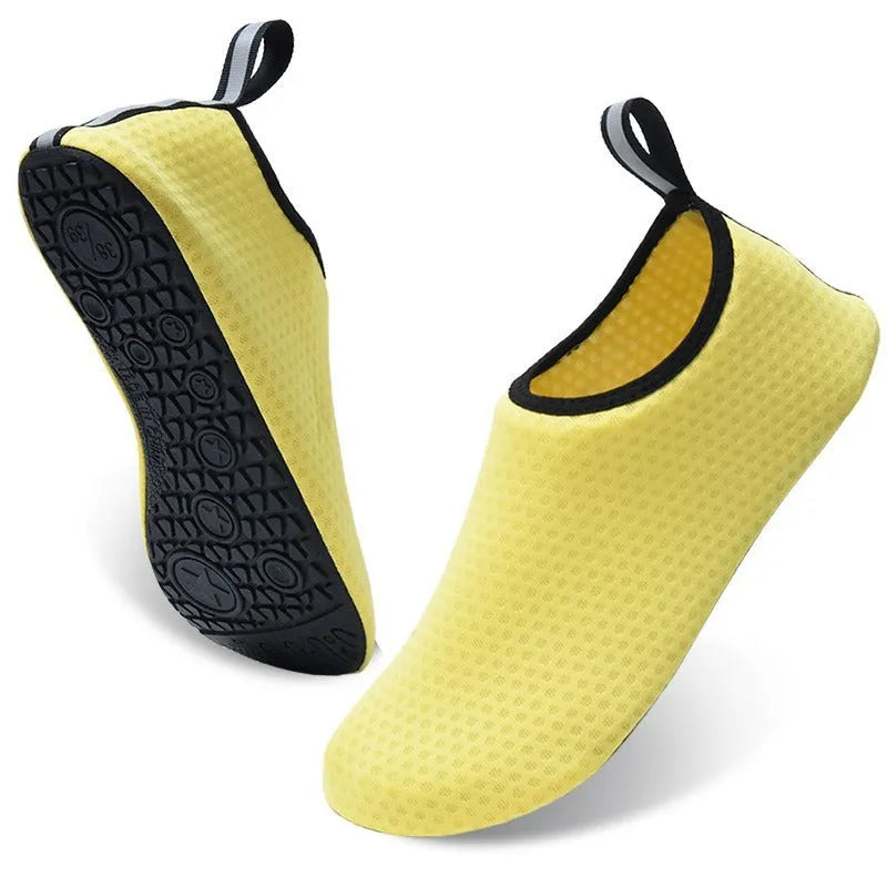 A pair of casual low-top beach shoes with a mesh upper, elastic band, and non-slip TPR outsole.