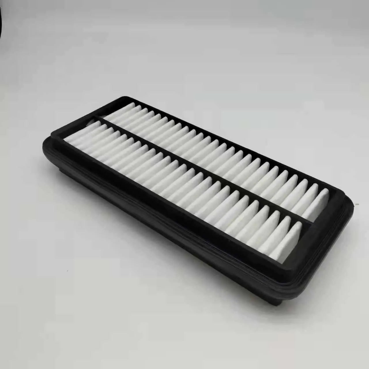 Black car air filter with dimensions 256mm by 113mm by 40mm for Modern vehicles