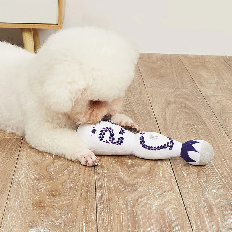 Red and white tequila bottle plush dog toy with squeaker for playful chewing and fetch games