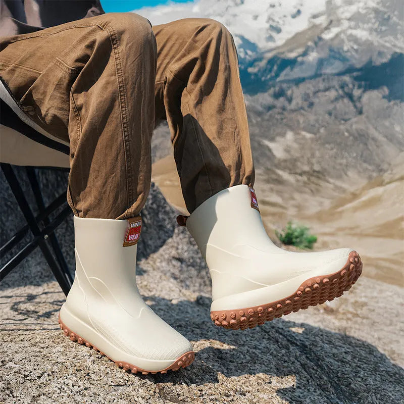 Men's mid-height PVC rain boot in beige with round toe and plastic sole.