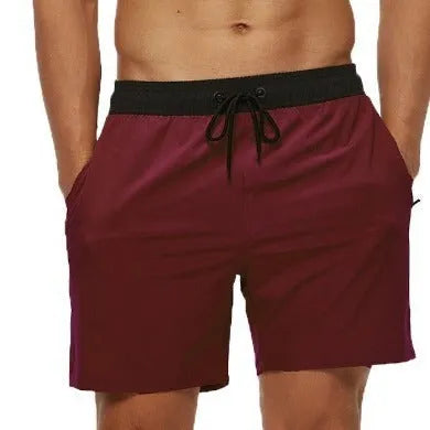 Men's blue athletic shorts with multiple pockets, drawstring waistband, and stitching detail for running and fitness activities