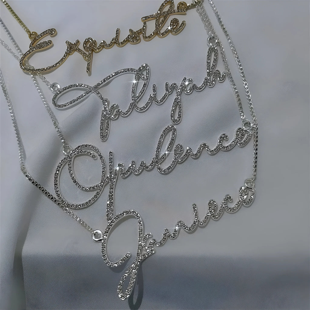 Personalised stainless steel name necklace with diamond-studded letters on a chain, shown in rose gold.