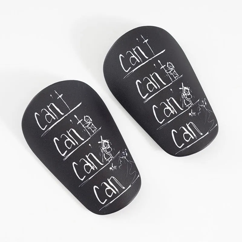 Pair of football shin guards in black colour showing front protective design