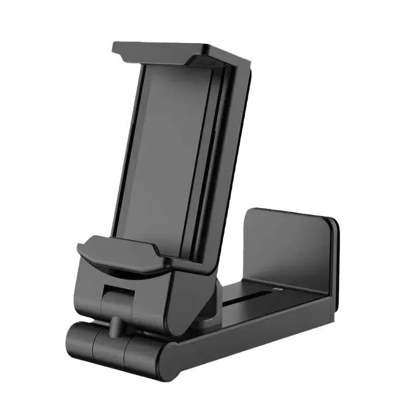 Black 360-degree rotating collapsible phone holder on desktop showing adjustable angle
