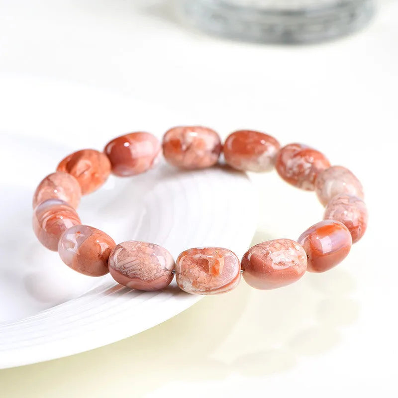 Natural cherry agate barrel shaped bead bracelet showing 10x14mm geometry design with Ruyi elements on wrist