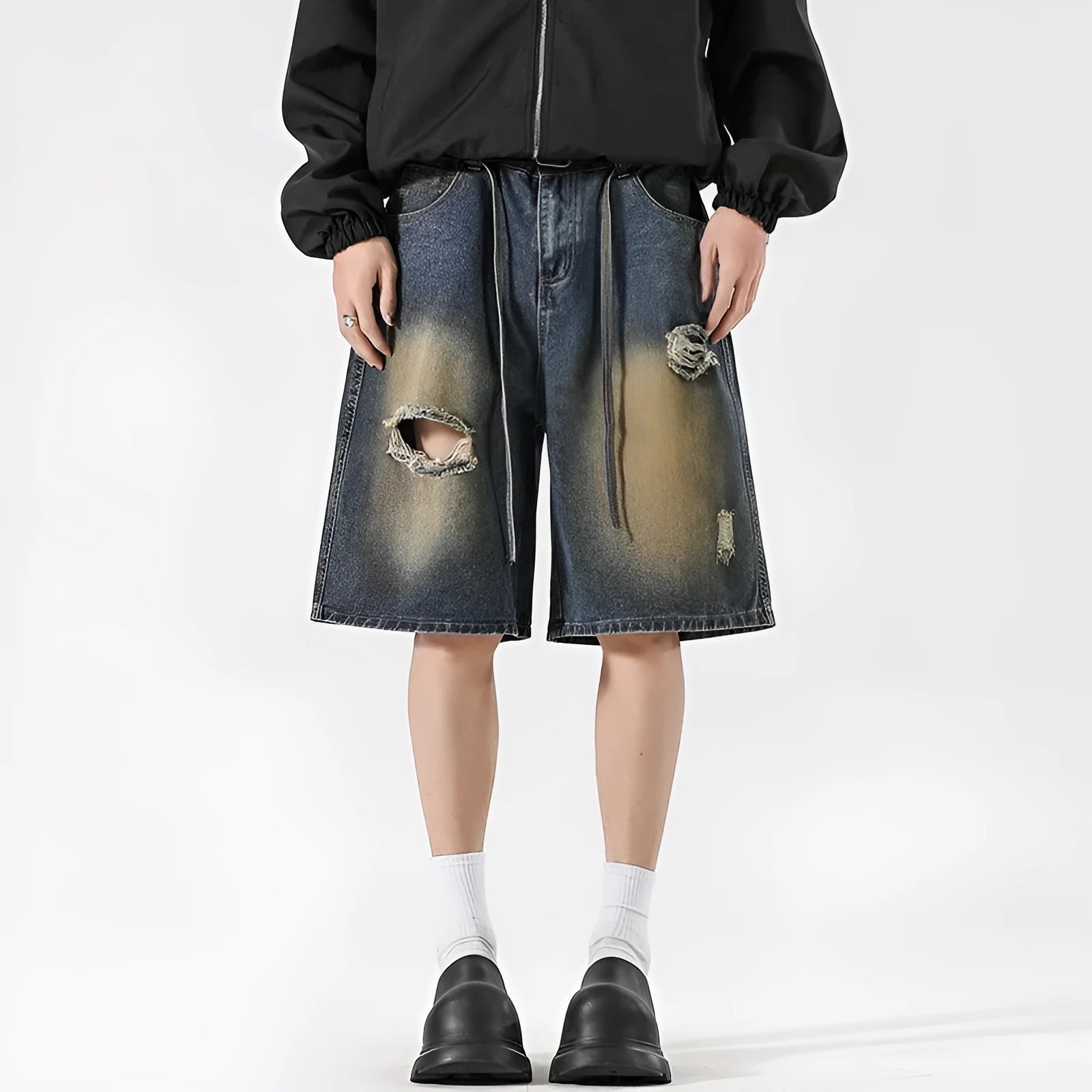 Loose fit retro blue distressed jeans on man showing cotton denim construction and street style detailing