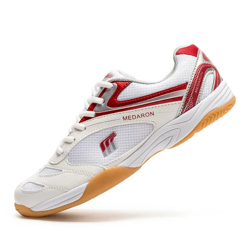 White and red table tennis sneakers with synthetic leather upper and lace-up front.