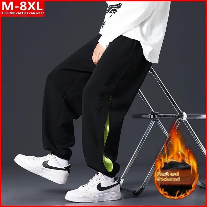 Men's ankle banded trousers in micro-elastic cotton with collage stitching, showing skinny leg and mid-waist fit.