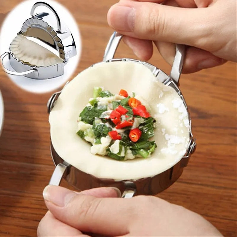 Stainless steel dumpling mould and rectangular dough cutter on a kitchen surface.