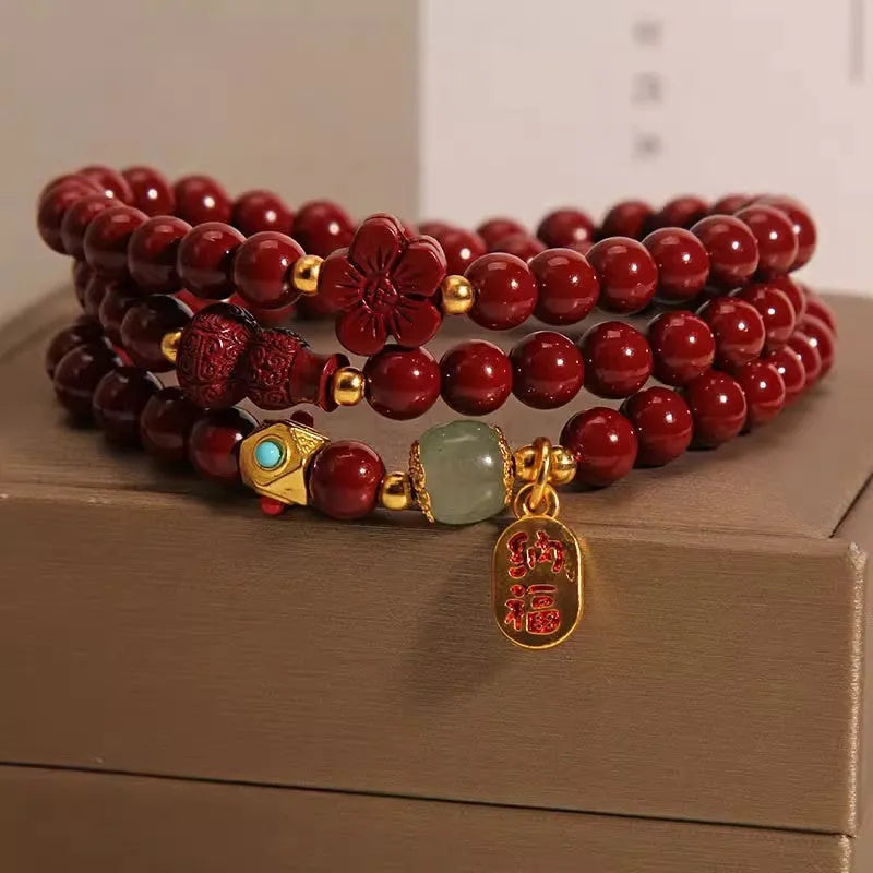 Red cinnabar bracelet with geometric gourd and flower design, 6mm diameter with clasp fastening