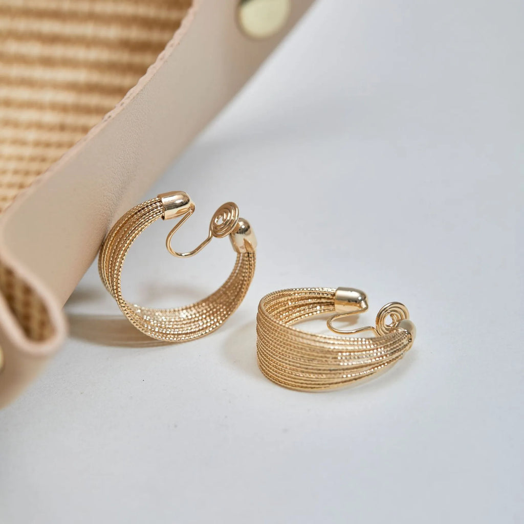 Geometric multi-layer copper earrings with electroplated silver or gold finish, showing stud and clip-on design options