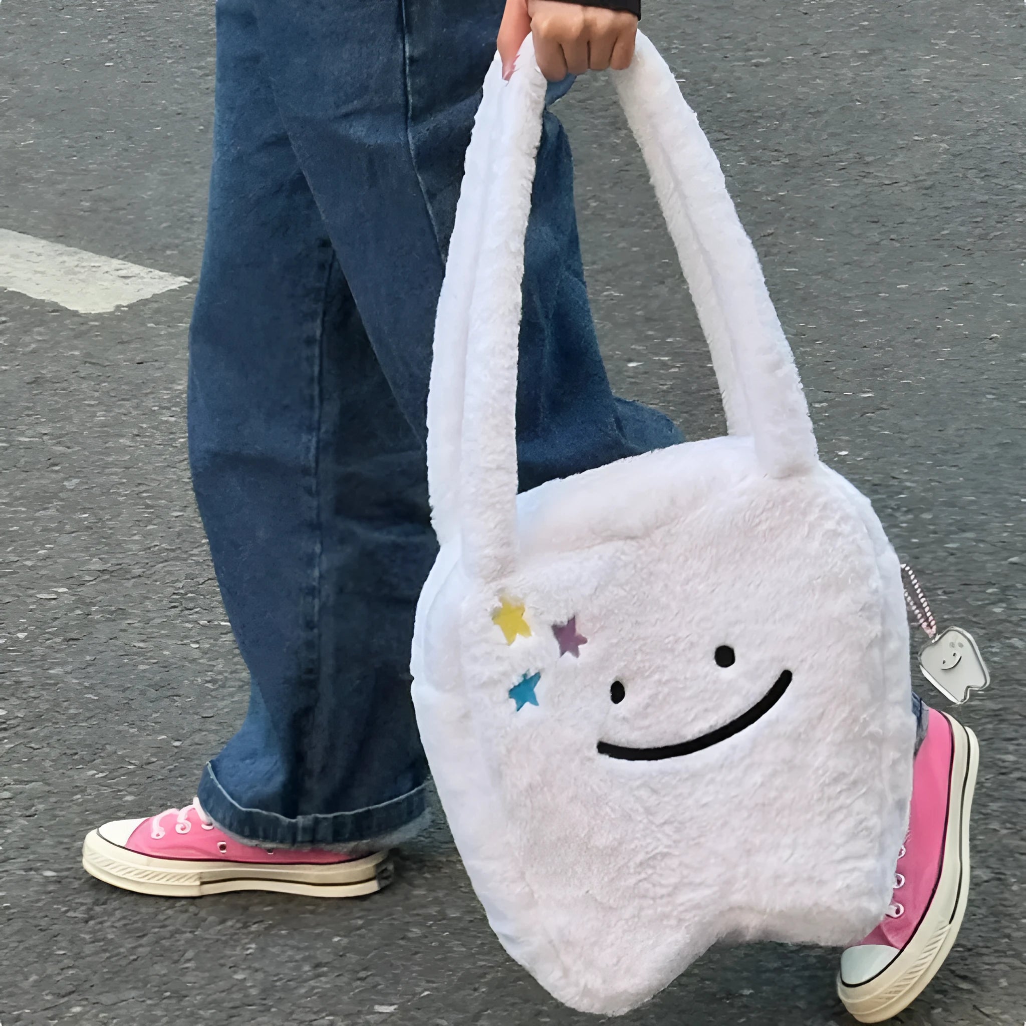 White plush tote bag with cute tooth graphic and a crossbody strap.