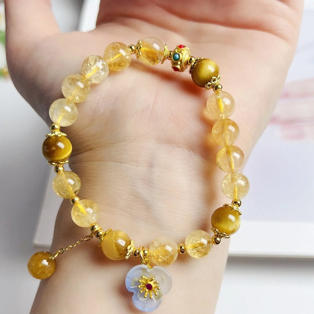 Handcrafted citrine crystal bracelet for women with a flower and tassel design.