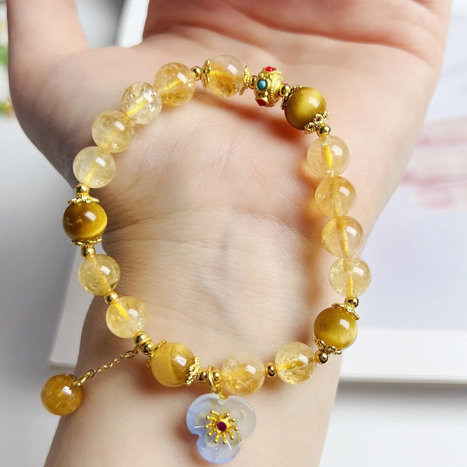 Handcrafted citrine crystal bracelet for women with a flower and tassel design.