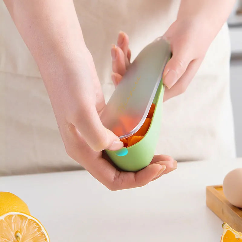 Green kitchen peeler with storage tube and stainless steel blade for fruit and vegetables