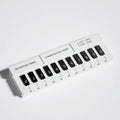 Black and white plastic piano-shaped temporary parking sign on a driveway