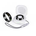 Black ceramic smart ring on finger showing health monitoring display with heart rate and blood oxygen readings