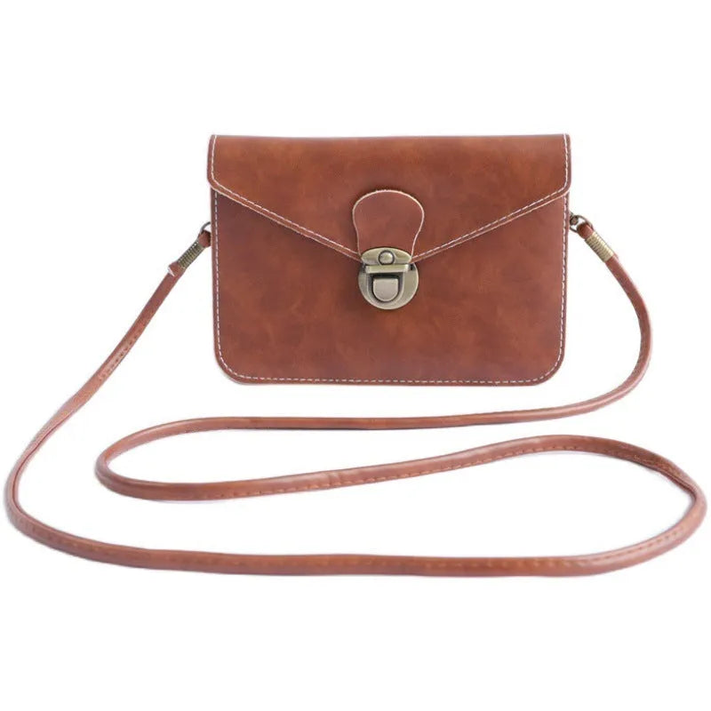 Retro soft-surface crossbody messenger bag with flap closure and lock detail in wine red colour