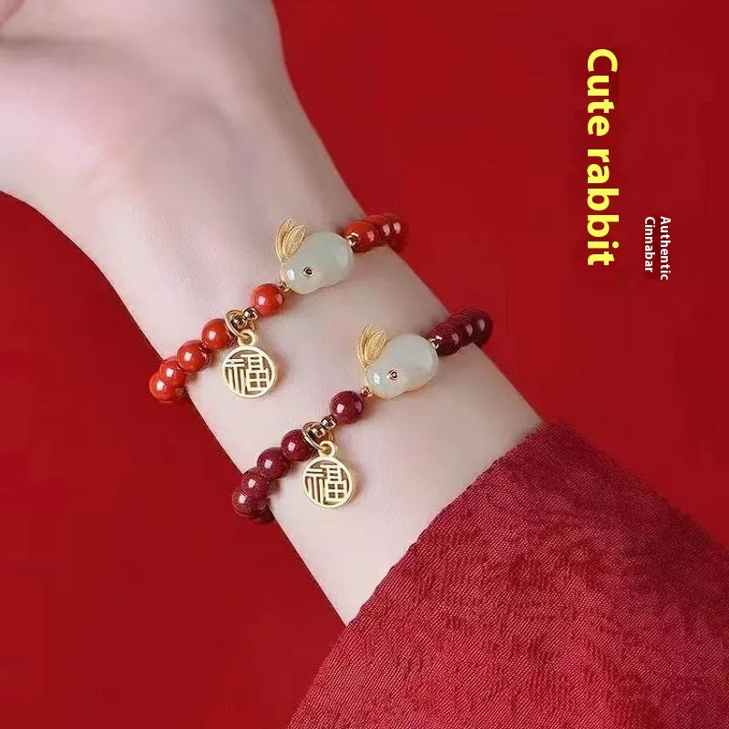 Cinnabar hare bracelet with purple gold sand beads on a wrist, showing retro jewellery style.