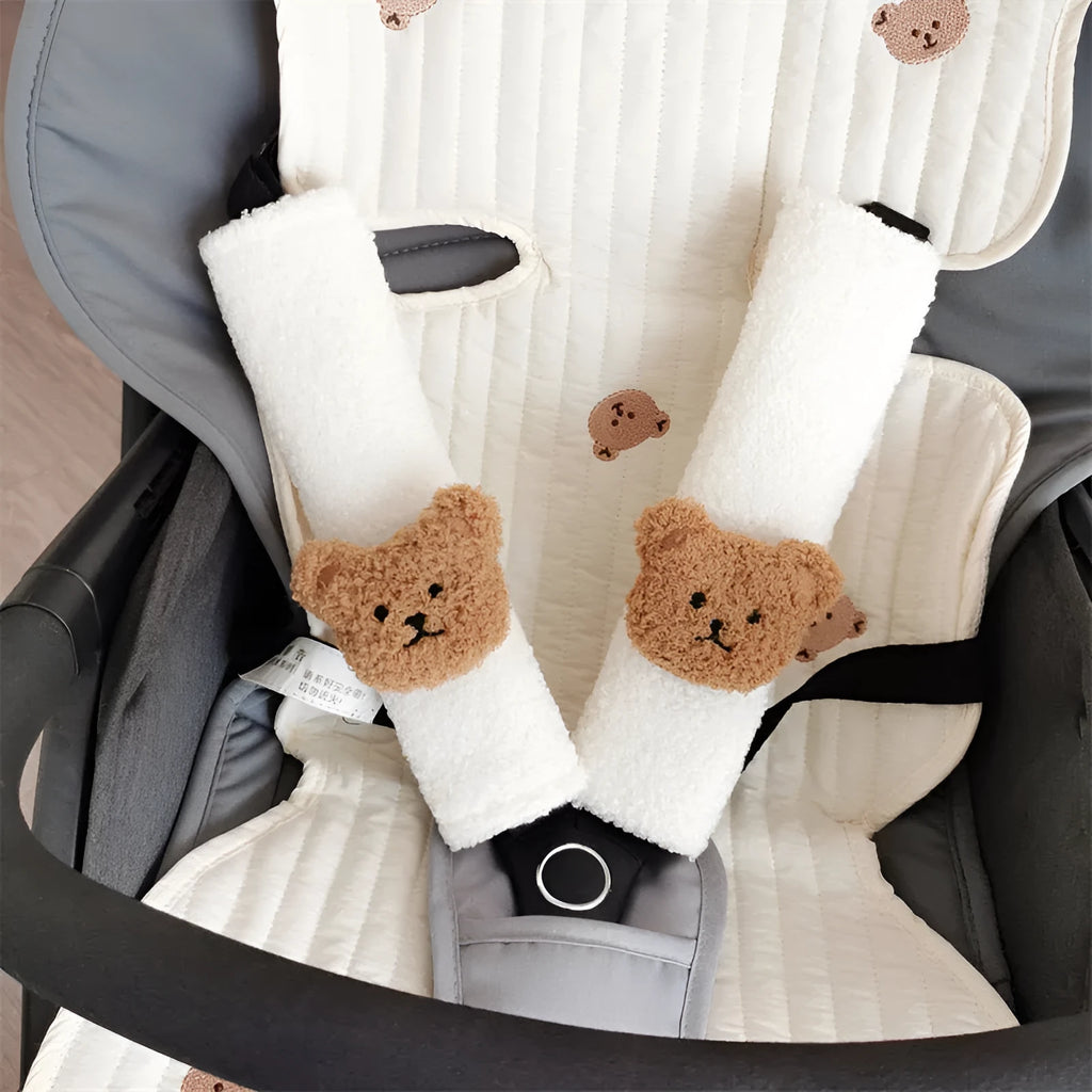Cartoon bear design plush car seat belt protective cover for infant safety, showing khaki and coffee colour options