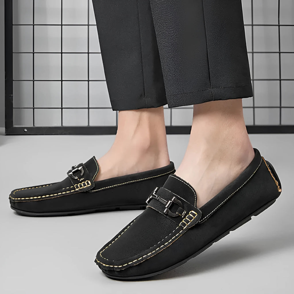 Men's beige slip-on loafers with a round toe and rubber sole on a plain background.