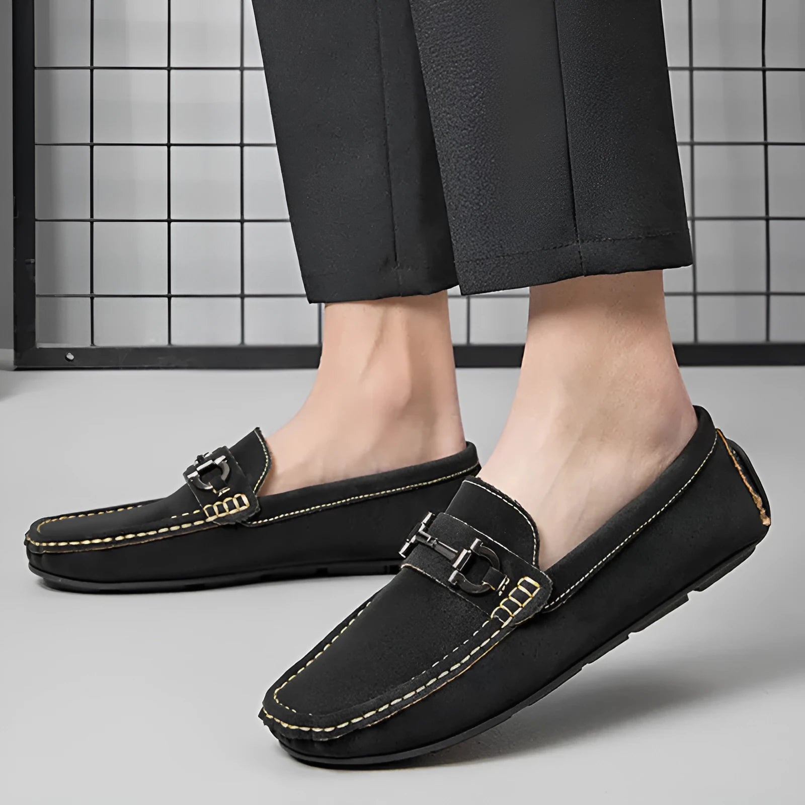 Men's beige slip-on loafers with a round toe and rubber sole on a plain background.