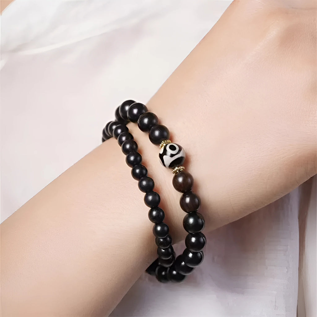 Solid ebony wood Tibetan bead bracelet with two circular 8mm beads on wrist