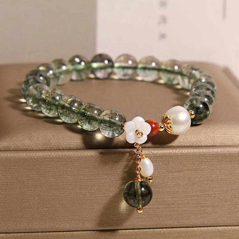 Green phantom quartz crystal bracelet with small bells of Ireland design and shell flower accents