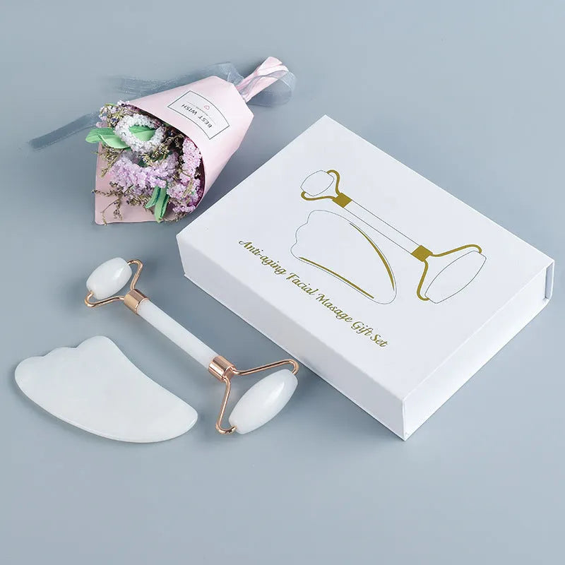 White jade facial roller with double-headed claw design and matching scraping board for manual massage