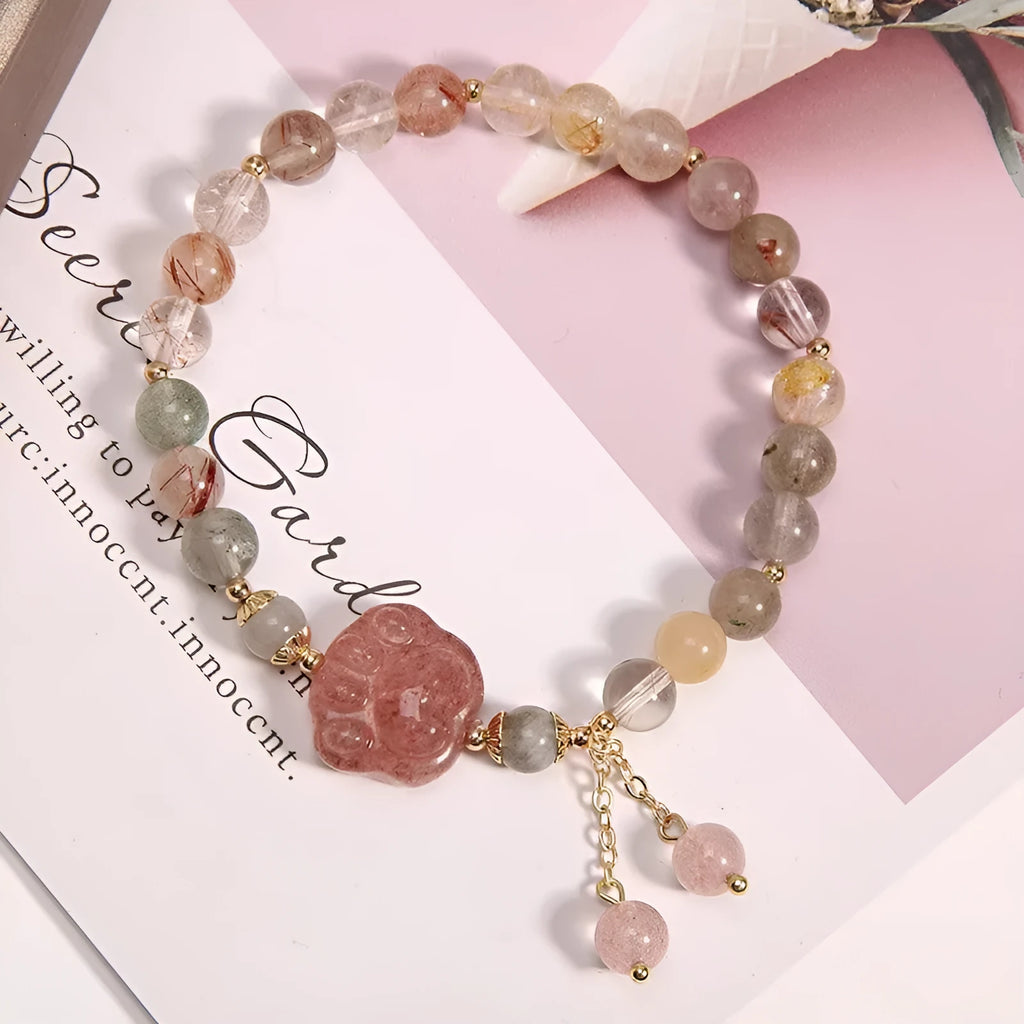 Colour hair crystal cat's paw charm bracelet with zircon butterfly on wrist.