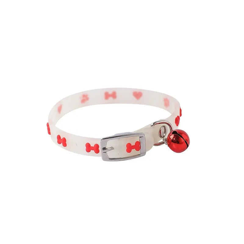 Luminous cat collar with a metal bell on an adjustable 29cm silicone strap, showing paw print design.