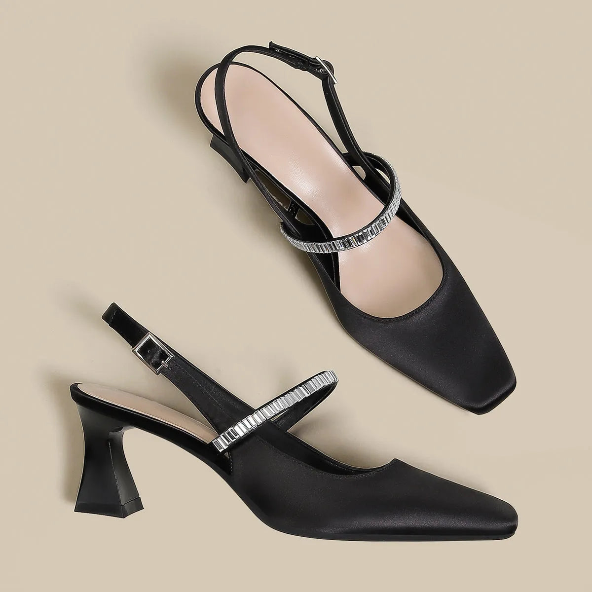 Black women's stiletto sandals with a pointed closed toe and a buckle strap around the ankle.