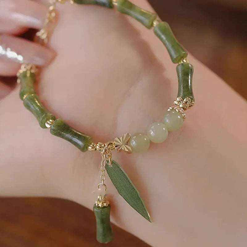 Chinese style bamboo leaf bracelet for women in glass with bamboo joint elements, showing manual processing and colour variations